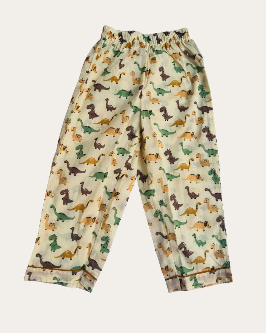 Children's pajama pants with dinosaur pattern on a beige background

