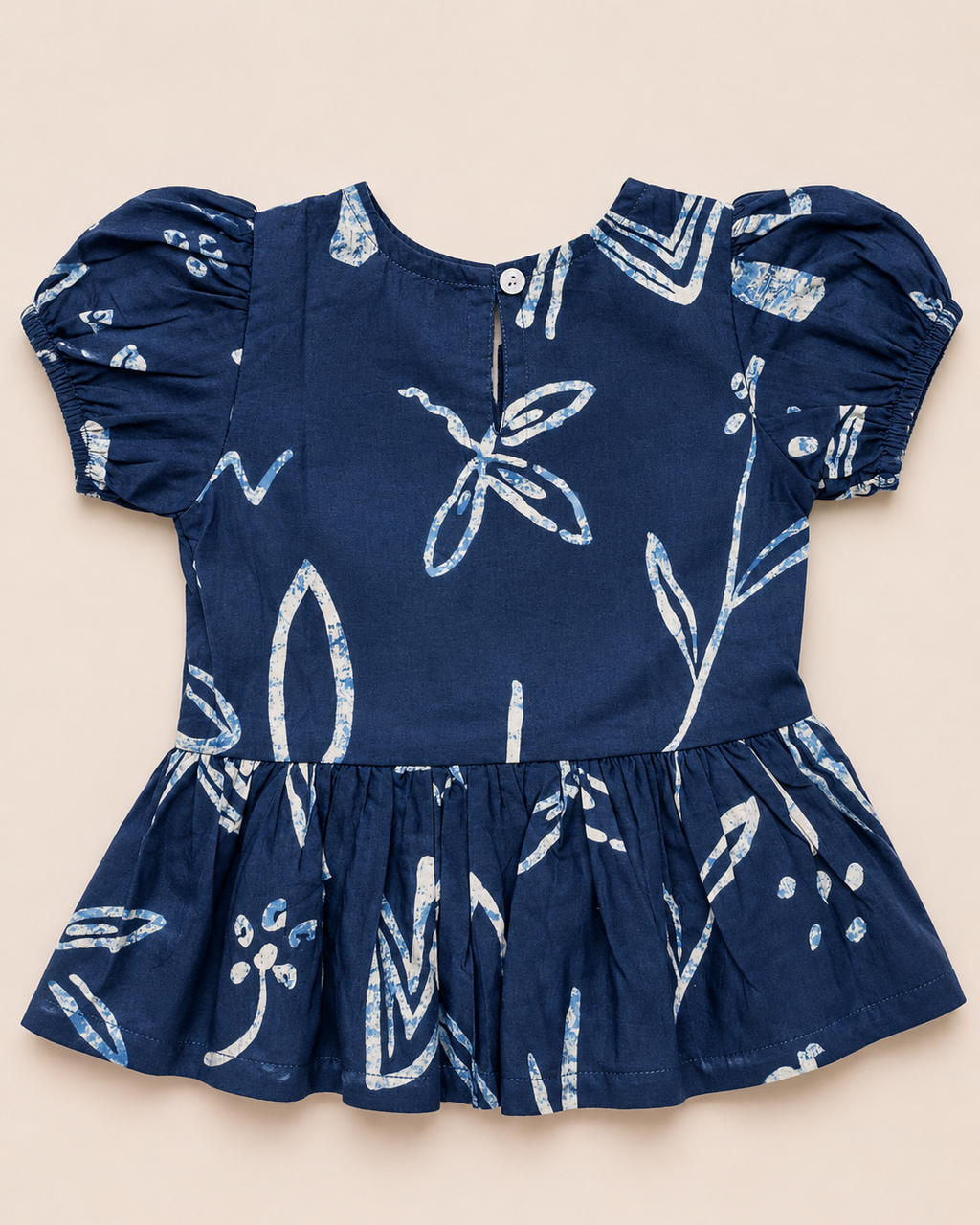 A navy blue outfit with white patterns, from Aruvo in beige color solid background