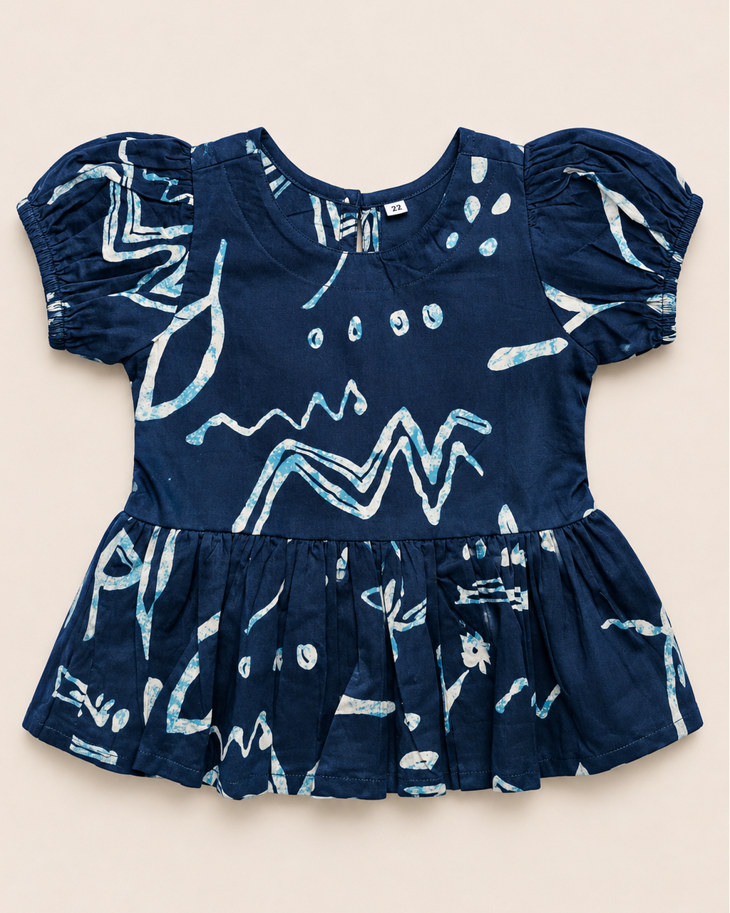 A navy blue outfit with white patterns, from Aruvo in beige color solid background