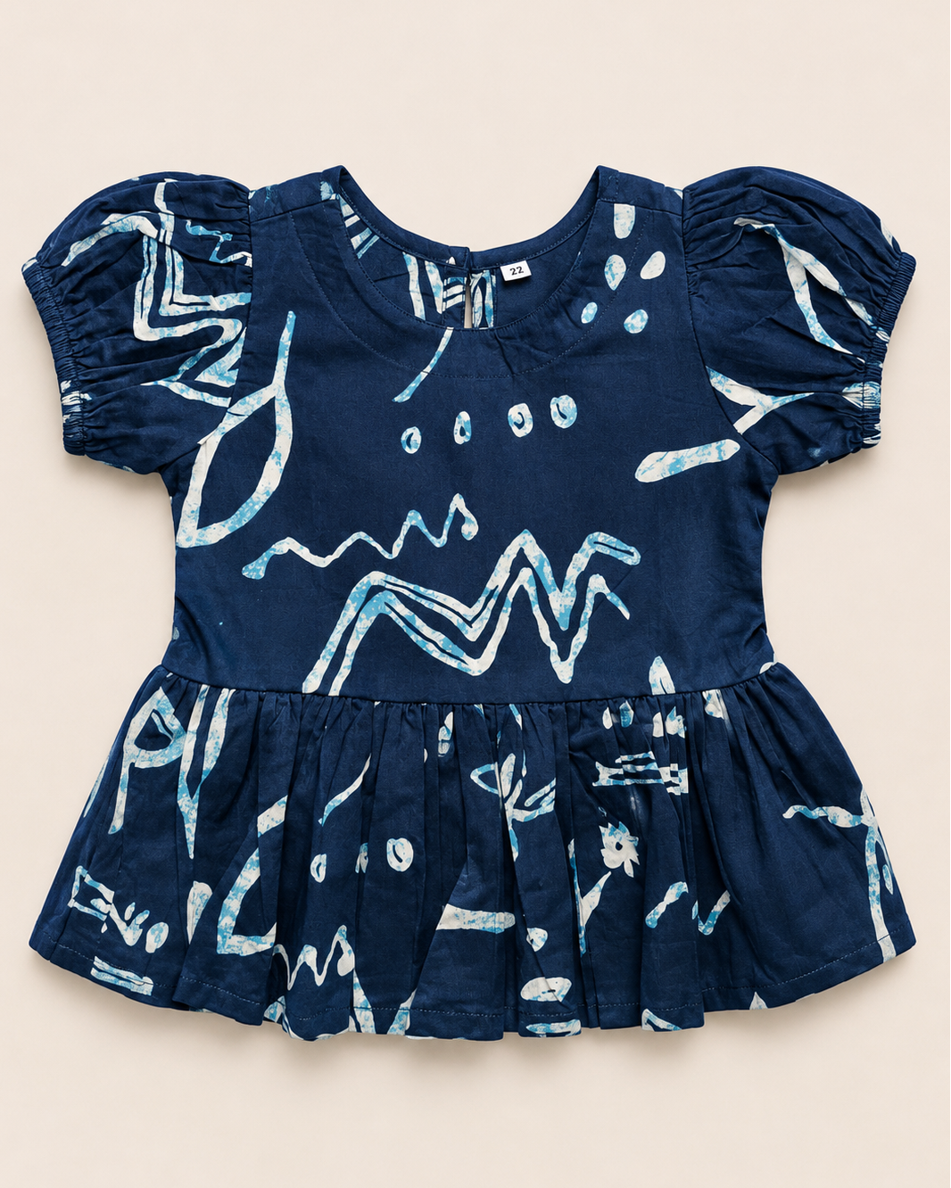 A navy blue outfit with white patterns, from Aruvo in beige color solid background