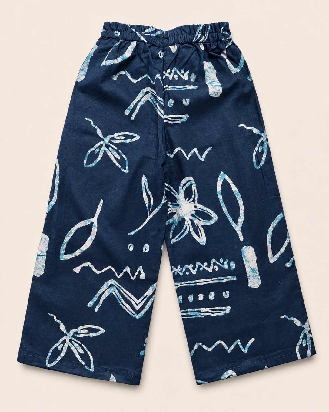 A navy blue outfit with white patterns, from Aruvo in beige color solid background