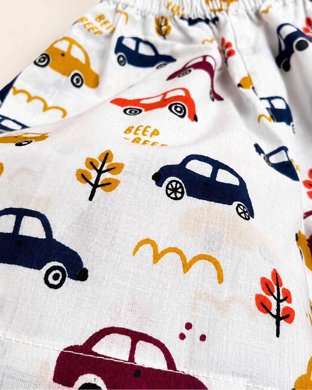 Set of children's pajama shorts with car pattern on a beige background from Aruvo