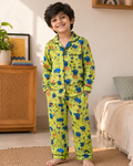 Child wearing green pajamas set with peppa from Aruvo in a bedroom setting