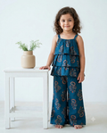 A young girl is wearing a strapped sleeve top with matching pant, crafted from 100% cotton fabric from Aruvo