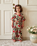 A girl is standing on white door wearing a kaftan crafted from 100% cotton fabric from Aruvo