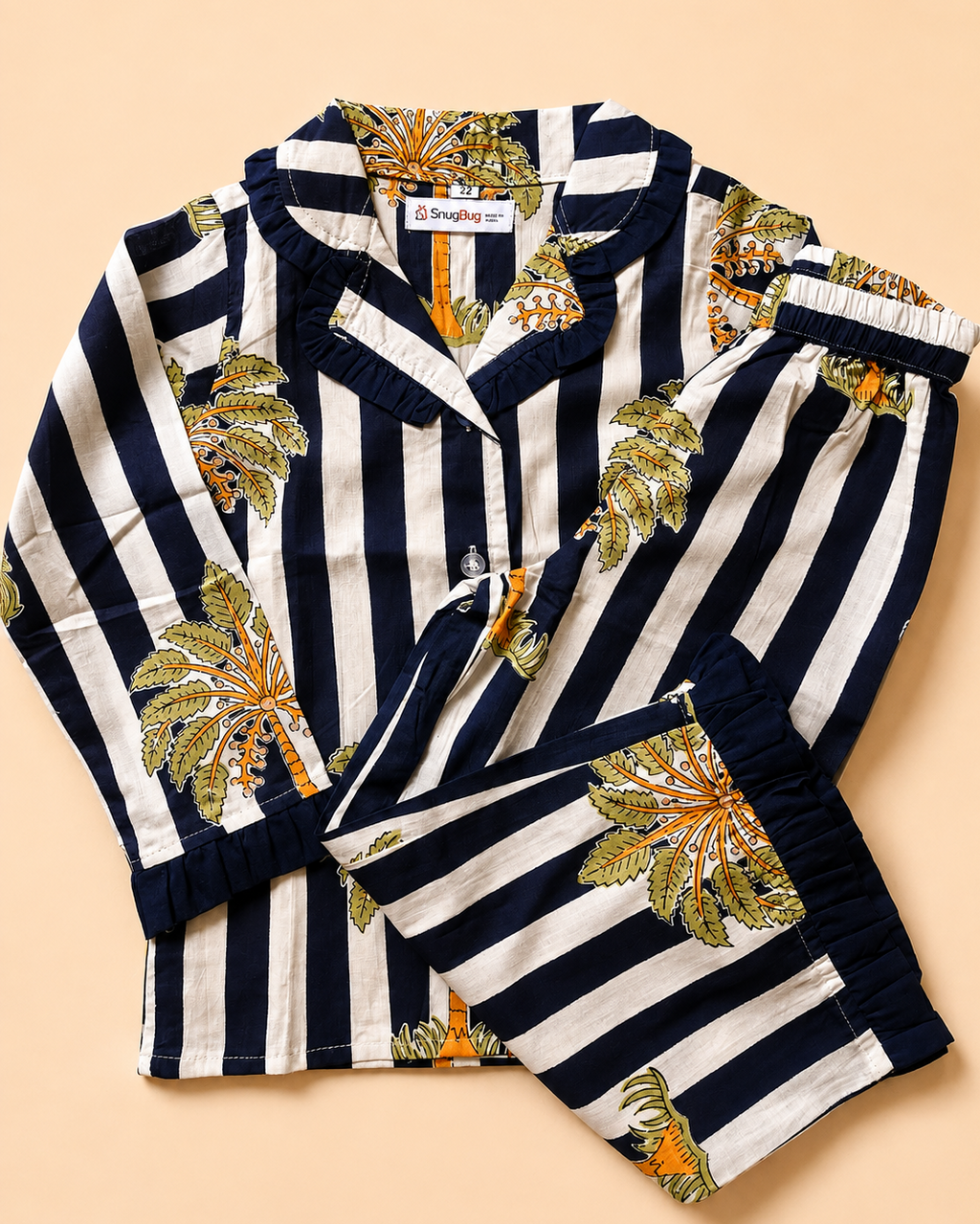 A striped Navy coconut printed Night suit set for girls from Aruvo is laid off on the floor of dark beige color