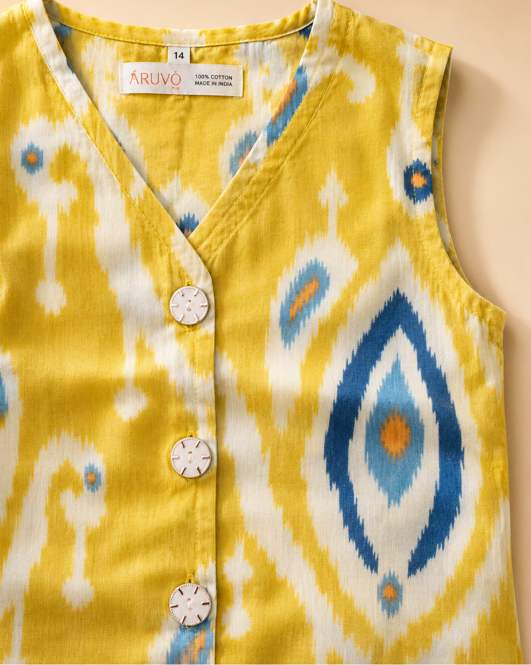 A sleeveless yellow V-neck vest with a blue, white, and orange ikat pattern, featuring three white buttons down the front. The brand name 'ARUVO' is visible on the inner neck label.