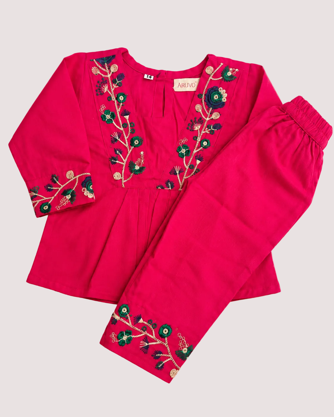 A bright pink two-piece children's outfit set consisting of a three-fourth sleeve top and matching pants, both decorated with colorful floral embroidery in green, blue, and gold along the neckline and cuffs, laid flat on a light beige background.