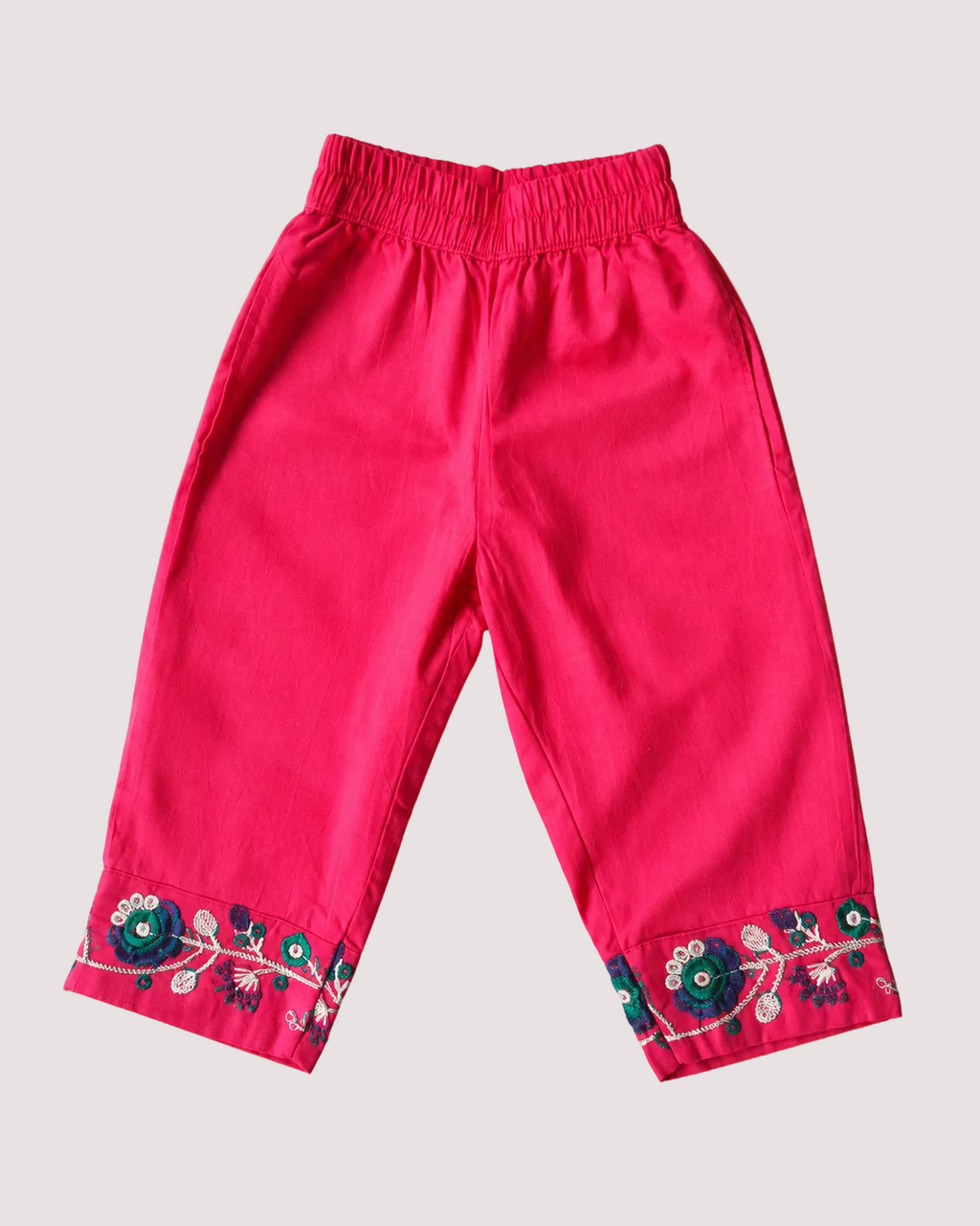 Bright pink pant with an elastic waistband and floral embroidered cuffs, from Aruvo