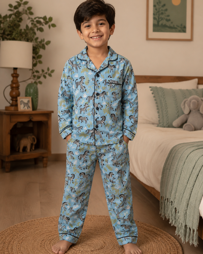 Child wearing premium cotton NightSuit with Zebra pattern in a bedroom 
