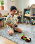 A toddler is playing with remote car, wearing Aruvo summer pure cotton, elephant printed co-ord set in white color
