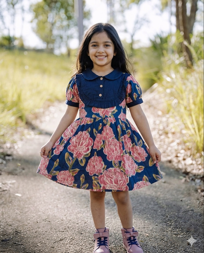 a little girls is wearing SnugBug Pure Cotton Summer Frock in navy blue color