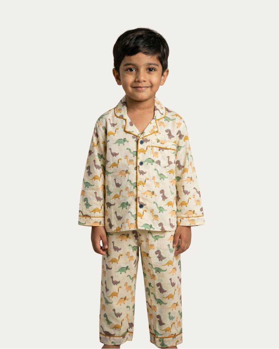 Child wearing a dinosaur-themed pajama set on a white background
