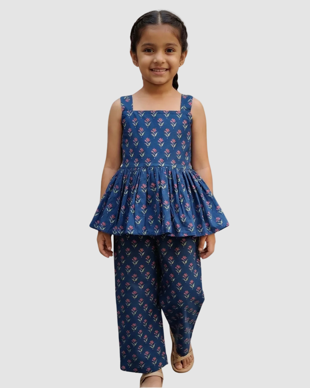 Young girl wearing a SnugBug's pure cotton blue floral top and pants, best for summer on a white background 
